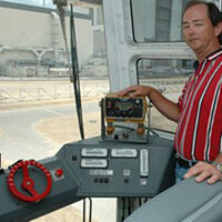 Bob Myers, a crawler systems engineer with United Space Alliance, stands beside the driver's console inside a Crawler-Transporter cab. Credit: NASA/KSC