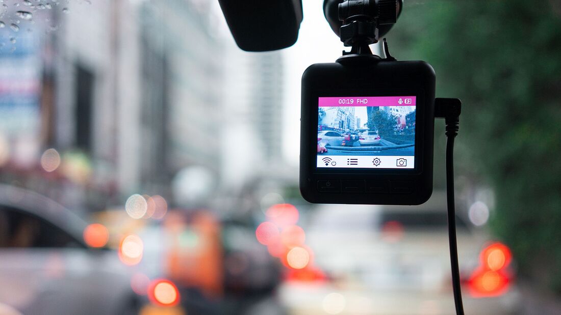 Close-Up Of Camera On Car Rear-View Mirror