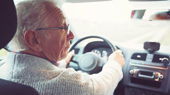 Old gentleman drives car